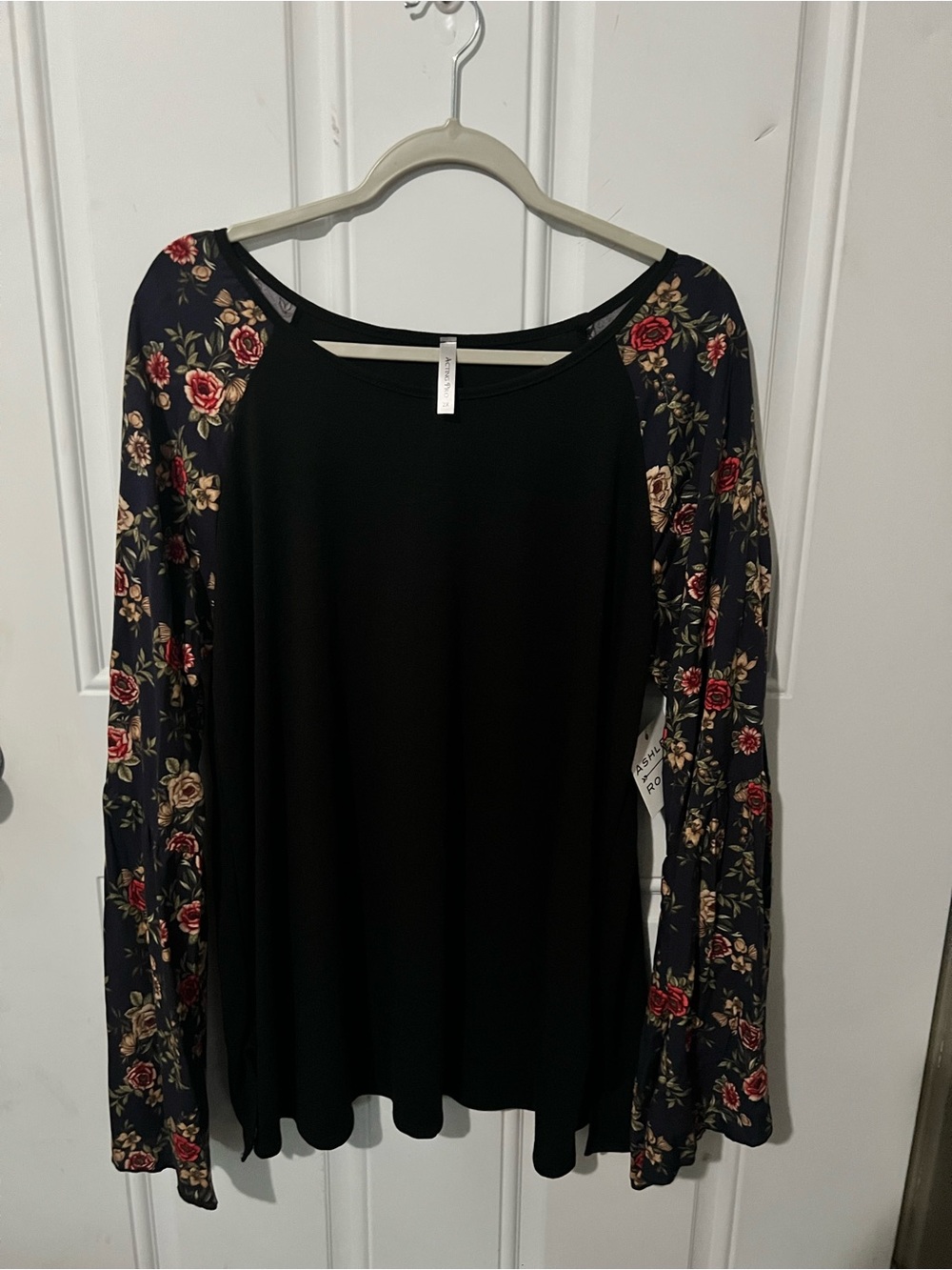 Solid blouse with floral bell sleeves.